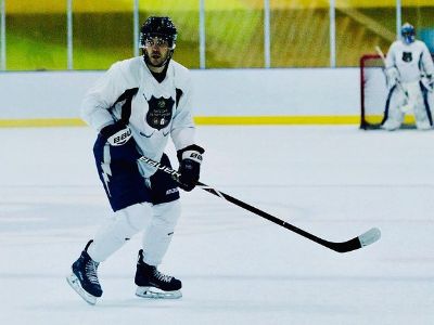 Taylor Kitsch is in his hockey outfit as he looks focused in the game.